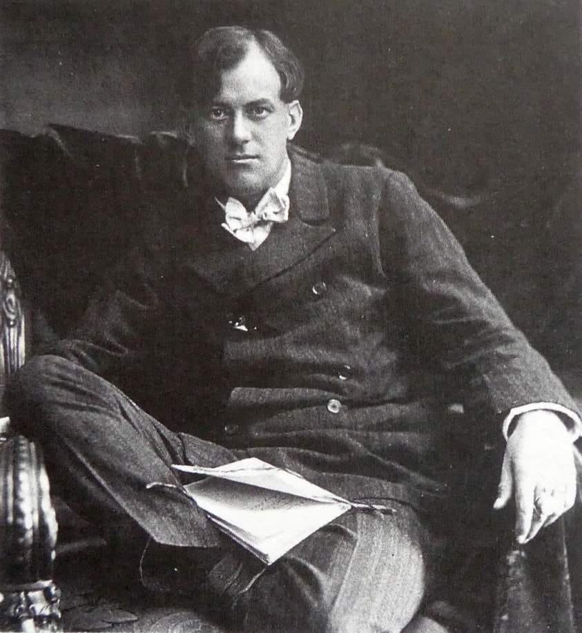 Aleister Crowley seated.