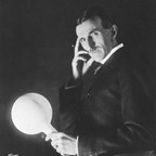 Nikola Tesla holding a glowing wireless lamp, Sarony studio portrait, 1898.