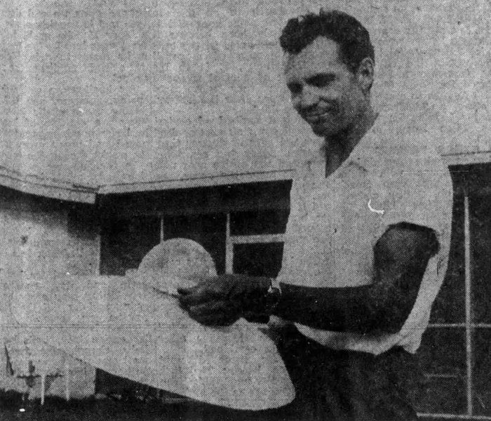 Howard Menger holding a radio-controlled model of a craft he claimed to have boarded.