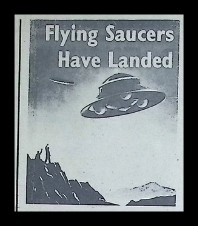 The title graphic from the serial: the words 'Flying Saucers Have Landed' above a saucer hovering over a rocky landscape with a small human figure.