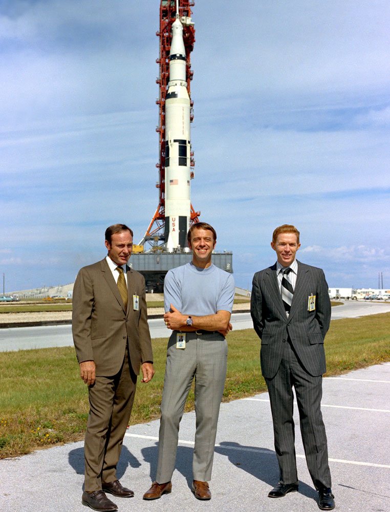 The Apollo 14 crew, Shepard, Roosa and Mitchell, in flight suits before their Saturn V rocket.